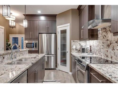 110 Cranford Close Se, Calgary, AB - Indoor Photo Showing Kitchen With Stainless Steel Kitchen With Double Sink With Upgraded Kitchen