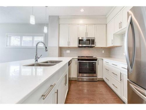 197 Silverado Plains Park Sw, Calgary, AB - Indoor Photo Showing Kitchen With Double Sink With Upgraded Kitchen