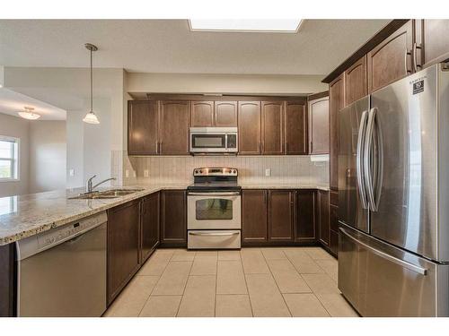 3304-4 Kingsland Close Se, Airdrie, AB - Indoor Photo Showing Kitchen With Stainless Steel Kitchen With Double Sink