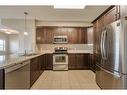 3304-4 Kingsland Close Se, Airdrie, AB  - Indoor Photo Showing Kitchen With Stainless Steel Kitchen With Double Sink 