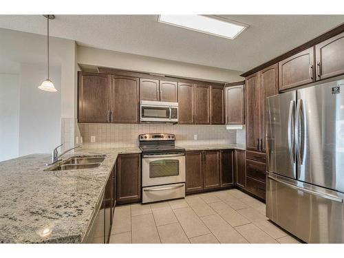 3304-4 Kingsland Close Se, Airdrie, AB - Indoor Photo Showing Kitchen With Stainless Steel Kitchen With Double Sink