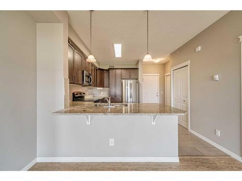 3304-4 Kingsland Close Se, Airdrie, AB - Indoor Photo Showing Kitchen With Stainless Steel Kitchen With Upgraded Kitchen