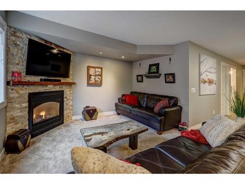 48 Hidden Spring Place Nw, Calgary, AB - Indoor Photo Showing Living Room With Fireplace