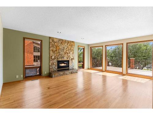 239 East Chestermere Drive, Chestermere, AB - Indoor Photo Showing Living Room With Fireplace