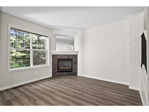 19-2318 17 Street Se, Calgary, AB - Indoor Photo Showing Living Room With Fireplace