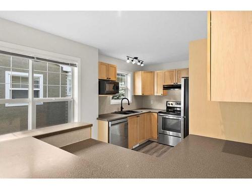 19-2318 17 Street Se, Calgary, AB - Indoor Photo Showing Kitchen With Stainless Steel Kitchen With Double Sink