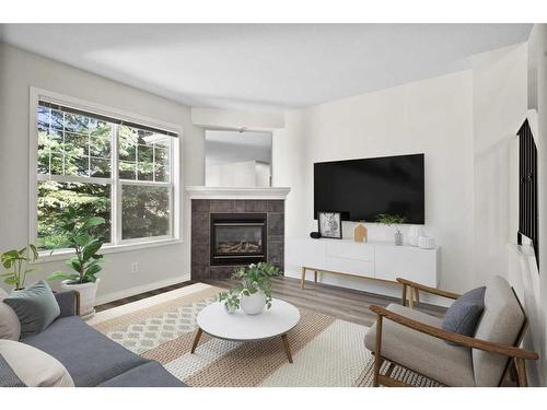 19-2318 17 Street Se, Calgary, AB - Indoor Photo Showing Living Room With Fireplace