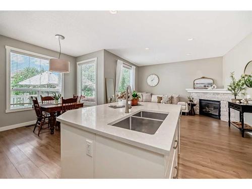 95 Elgin Drive Se, Calgary, AB - Indoor Photo Showing Kitchen With Fireplace With Double Sink