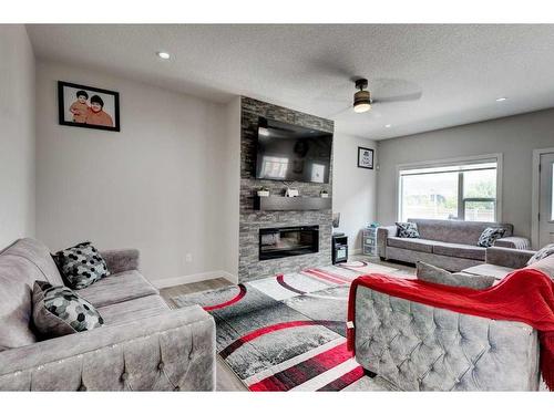 61 Saddlestone Park Ne, Calgary, AB - Indoor Photo Showing Living Room With Fireplace