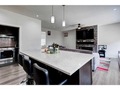 61 Saddlestone Park Ne, Calgary, AB - Indoor Photo Showing Kitchen With Fireplace