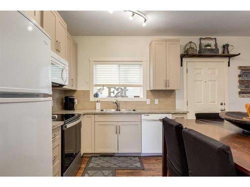 576-500 Harrison Court, Crossfield, AB - Indoor Photo Showing Kitchen With Double Sink