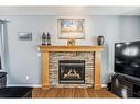 195 West Creek Landing, Chestermere, AB  - Indoor Photo Showing Living Room With Fireplace 