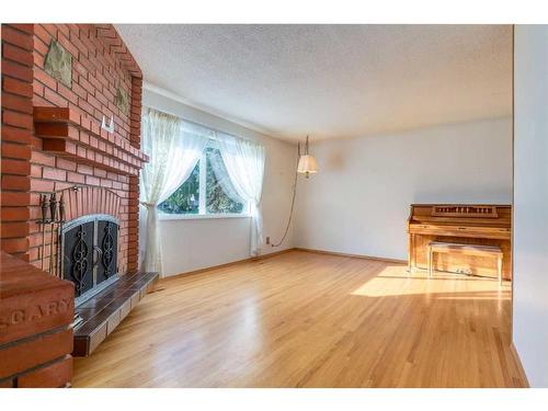 56 Huntwick Way Ne, Calgary, AB - Indoor Photo Showing Living Room With Fireplace