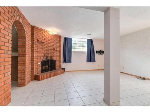 56 Huntwick Way Ne, Calgary, AB - Indoor Photo Showing Other Room With Fireplace