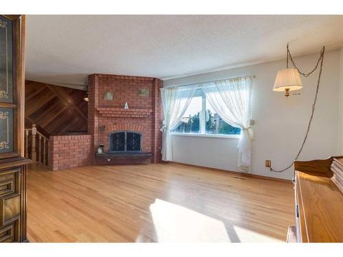 56 Huntwick Way Ne, Calgary, AB - Indoor Photo Showing Living Room With Fireplace