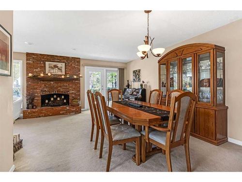 124 Midpark Drive Se, Calgary, AB - Indoor Photo Showing Dining Room With Fireplace