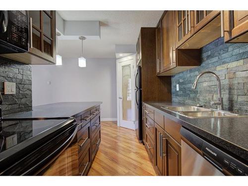 210-515 57 Avenue Sw, Calgary, AB - Indoor Photo Showing Kitchen With Double Sink