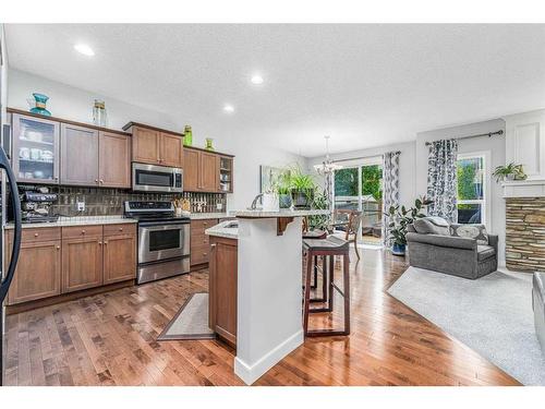 11 Aspen Hills Close Sw, Calgary, AB - Indoor Photo Showing Kitchen With Fireplace