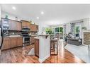 11 Aspen Hills Close Sw, Calgary, AB  - Indoor Photo Showing Kitchen With Fireplace 