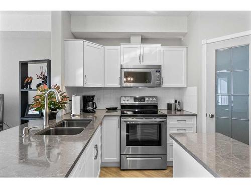 2345-151 Country Village Road Ne, Calgary, AB - Indoor Photo Showing Kitchen With Stainless Steel Kitchen With Double Sink With Upgraded Kitchen