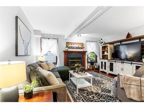 10 Tipping Close Se, Airdrie, AB - Indoor Photo Showing Living Room With Fireplace