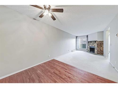 208-2218 30 Street Sw, Calgary, AB - Indoor Photo Showing Other Room With Fireplace