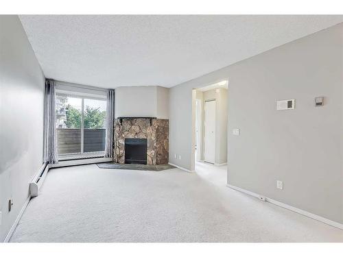 208-2218 30 Street Sw, Calgary, AB - Indoor Photo Showing Living Room With Fireplace