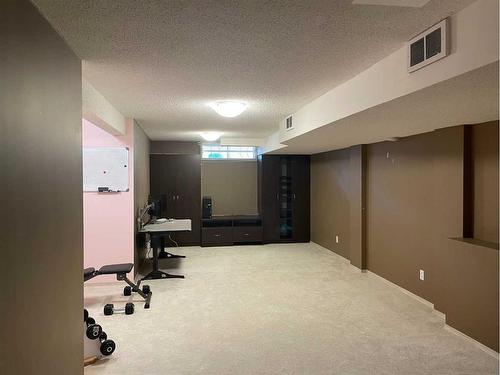 65 Shawnee Crescent Sw, Calgary, AB - Indoor Photo Showing Gym Room