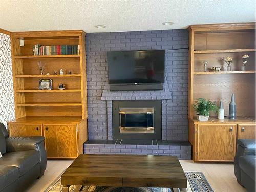 65 Shawnee Crescent Sw, Calgary, AB - Indoor Photo Showing Living Room With Fireplace