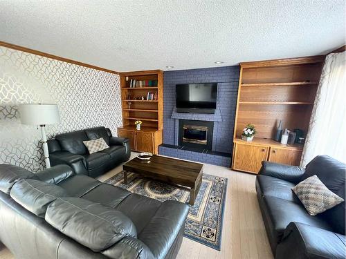 65 Shawnee Crescent Sw, Calgary, AB - Indoor Photo Showing Living Room With Fireplace