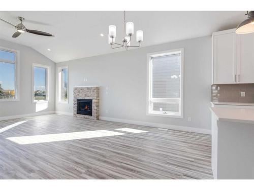 20 Country Meadows Cove, Diamond Valley, AB - Indoor Photo Showing Living Room With Fireplace