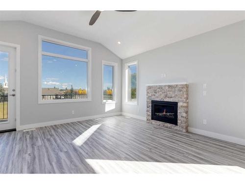 20 Country Meadows Cove, Diamond Valley, AB - Indoor Photo Showing Living Room With Fireplace