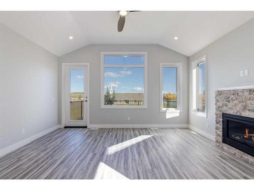 20 Country Meadows Cove, Diamond Valley, AB - Indoor Photo Showing Living Room With Fireplace