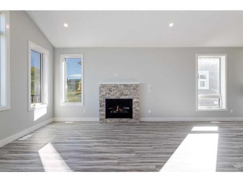 20 Country Meadows Cove, Diamond Valley, AB - Indoor Photo Showing Living Room With Fireplace