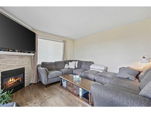 #-3318 Tuscarora Manor Nw, Calgary, AB - Indoor Photo Showing Living Room With Fireplace