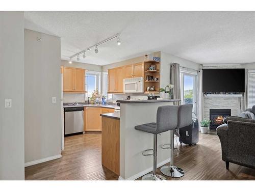 #-3318 Tuscarora Manor Nw, Calgary, AB - Indoor Photo Showing Kitchen With Fireplace