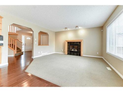 322 Cranfield Gardens Se, Calgary, AB - Indoor Photo Showing Living Room With Fireplace