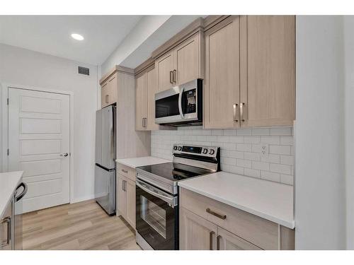 311-80 Carrington Plaza Nw, Calgary, AB - Indoor Photo Showing Kitchen With Stainless Steel Kitchen