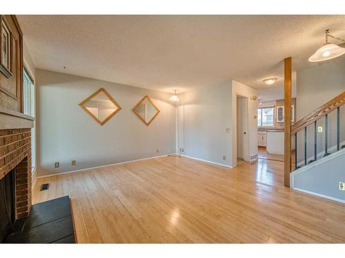 4 Edgedale Court Nw, Calgary, AB - Indoor Photo Showing Other Room With Fireplace