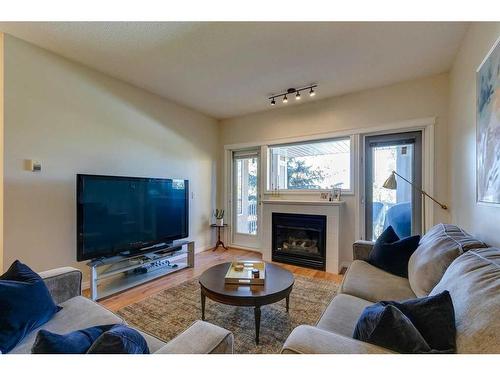 311-4507 45 Street Sw, Calgary, AB - Indoor Photo Showing Living Room With Fireplace