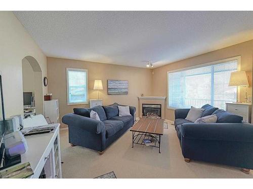 133 Citadel Pointe Nw, Calgary, AB - Indoor Photo Showing Living Room With Fireplace