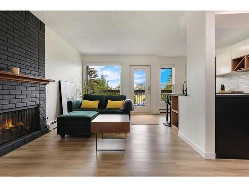 104-205 5 Avenue Ne, Calgary, AB - Indoor Photo Showing Living Room With Fireplace