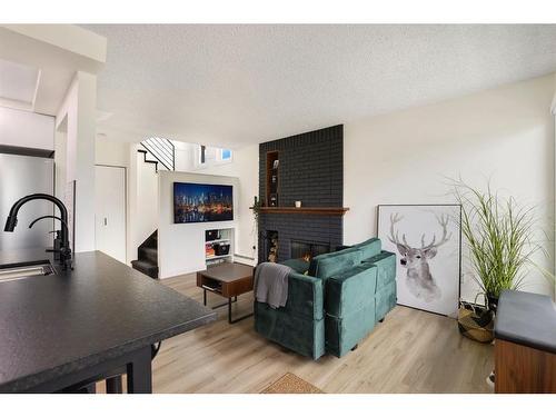 104-205 5 Avenue Ne, Calgary, AB - Indoor With Fireplace