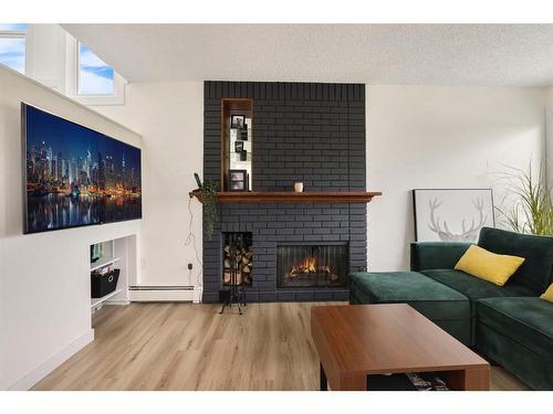 104-205 5 Avenue Ne, Calgary, AB - Indoor Photo Showing Living Room With Fireplace