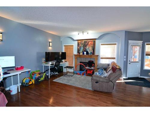 321 Crystal Shores View, Okotoks, AB - Indoor Photo Showing Living Room With Fireplace