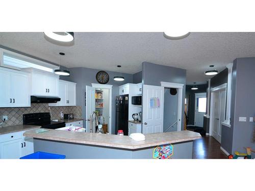 321 Crystal Shores View, Okotoks, AB - Indoor Photo Showing Kitchen With Double Sink