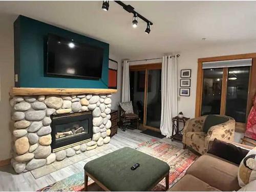 202-743 Railway Avenue, Canmore, AB - Indoor Photo Showing Living Room With Fireplace