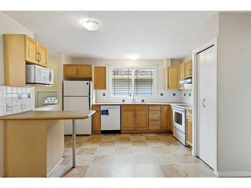 5A Radcliffe Crescent Se, Calgary, AB - Indoor Photo Showing Kitchen With Double Sink