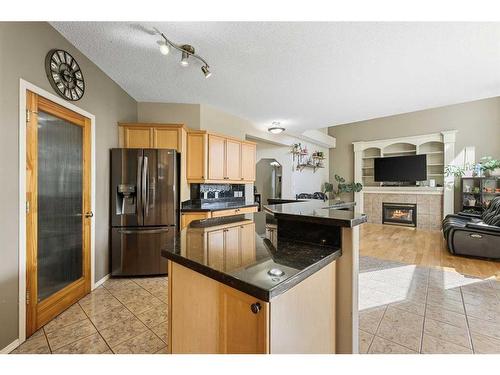 8 Mt Douglas Circle Se, Calgary, AB - Indoor Photo Showing Kitchen With Fireplace