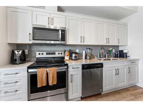 208-30 Walgrove Walk Se, Calgary, AB - Indoor Photo Showing Kitchen With Stainless Steel Kitchen With Double Sink